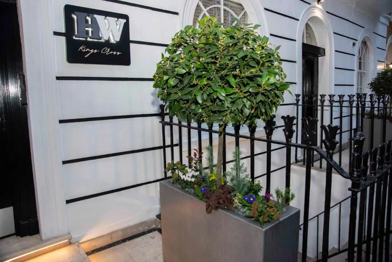 a plant in a planter next to a building at Howard Winchester Hotel in London